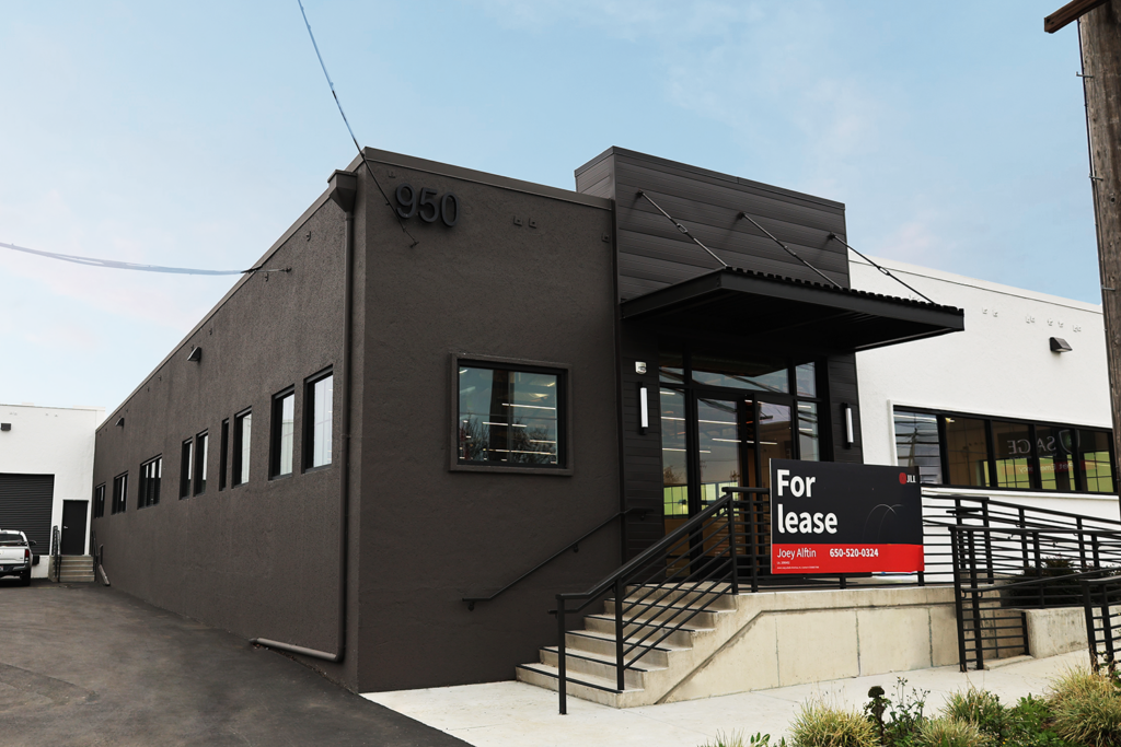 Clean, linear lighting defines this open-warehouse space in Redwood City, where efficient electrical systems and precise layout come together to support performance, visibility, and a modern industrial environment.