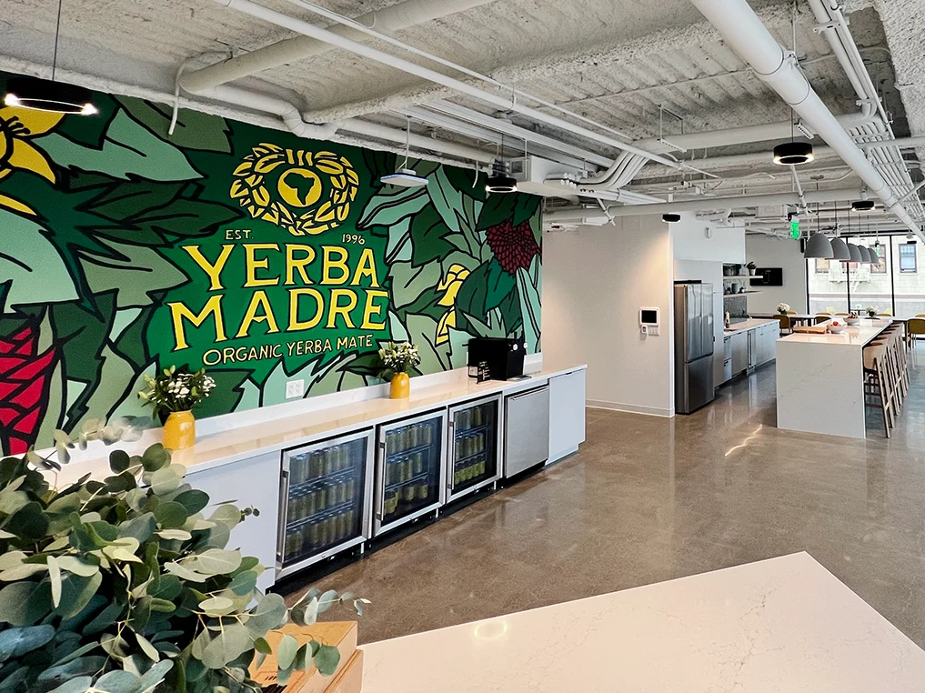 Yerba Madre office kitchen and branded mural wall after electrical tenant improvements